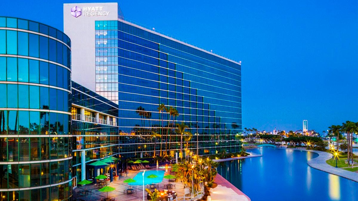 aerial of exterior of Hyatt Regency Long Beach with view of large pool in California, USA during day with blue sky